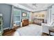 Bright Bedroom with hardwood floors, neutral rug, and crib next to a changing table and dresser at 2143 Yancey Ne Ln, Atlanta, GA 30319