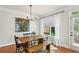 Elegant dining room featuring a wooden table, black chairs, a chandelier, and hardwood floors at 2143 Yancey Ne Ln, Atlanta, GA 30319
