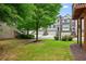 Townhouse exterior showing brick facade, multiple garages, and a lawn area with manicured shrubs at 2143 Yancey Ne Ln, Atlanta, GA 30319