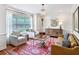 Elegant living room featuring neutral furniture, a chandelier, hardwood floors, and ample natural light at 2143 Yancey Ne Ln, Atlanta, GA 30319