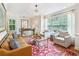 Inviting living room featuring stylish seating, a glass coffee table, hardwood floors, and bright natural light at 2143 Yancey Ne Ln, Atlanta, GA 30319