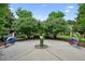 The landscaped butterfly garden boasts whimsical metal butterfly art, lush greenery, and a charming water feature at 2143 Yancey Ne Ln, Atlanta, GA 30319