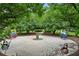 The landscaped butterfly garden boasts whimsical metal butterfly art, lush greenery, and a charming water feature at 2143 Yancey Ne Ln, Atlanta, GA 30319