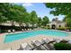 Inviting community pool surrounded by mature trees and comfortable lounge chairs for relaxation and enjoyment at 2143 Yancey Ne Ln, Atlanta, GA 30319