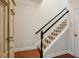 Carpeted staircase with black handrail with white trim, leading upstairs. Wood flooring on the lower level at 2143 Yancey Ne Ln, Atlanta, GA 30319