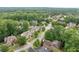 Aerial view of a suburban neighborhood with lush green trees and well-maintained homes on quiet, tree-lined streets at 2239 Tayside Nw Xing, Kennesaw, GA 30152