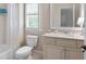 Bright bathroom featuring shower, tub, toilet, vanity, and window at 2239 Tayside Nw Xing, Kennesaw, GA 30152