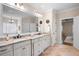 Bright bathroom features a double vanity with granite countertop and travertine floors at 2239 Tayside Nw Xing, Kennesaw, GA 30152