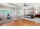 Bright bedroom with hardwood floors, sitting area, and four-poster bed at 2239 Tayside Nw Xing, Kennesaw, GA 30152