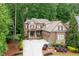 Beautiful two-story home with a brick and stone facade, lush landscaping, and a spacious driveway at 2239 Tayside Nw Xing, Kennesaw, GA 30152