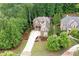 Stunning two-story brick home with a manicured lawn, mature trees, and a long driveway leading to a welcoming entrance at 2239 Tayside Nw Xing, Kennesaw, GA 30152