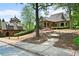 Charming building with brick facade, covered entrance and manicured landscaping along a street with sidewalks and mature trees at 2239 Tayside Nw Xing, Kennesaw, GA 30152