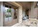 Charming covered porch with stone flooring, comfortable seating, and elegant architectural details at 2239 Tayside Nw Xing, Kennesaw, GA 30152