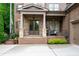 Inviting front porch with stone accents, cozy seating, and stylish lighting fixtures at 2239 Tayside Nw Xing, Kennesaw, GA 30152