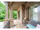 Covered entry with stone columns, stylish lighting, and cozy seating area on the front porch at 2239 Tayside Nw Xing, Kennesaw, GA 30152