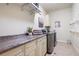 Functional laundry room with counter space, storage cabinets, washer, and dryer at 2239 Tayside Nw Xing, Kennesaw, GA 30152