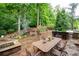 Outdoor dining area with stone patio, built-in grill, bar seating, and lush landscaping creates a great spot to entertain at 2239 Tayside Nw Xing, Kennesaw, GA 30152