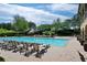 Community pool surrounded by lounge chairs and lush trees on a sunny day at 2239 Tayside Nw Xing, Kennesaw, GA 30152