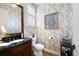 Elegant powder room boasts custom wallpaper, vanity with dark countertop, and stylish decor at 2239 Tayside Nw Xing, Kennesaw, GA 30152