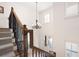 Staircase featuring hardwood floors, carpet runner, and a hanging light fixture at 2239 Tayside Nw Xing, Kennesaw, GA 30152