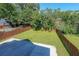 Large, level backyard featuring lawn, concrete area and wooden fence at 3416 Harrison Rd, Atlanta, GA 30344
