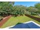 Large backyard featuring lawn, concrete patio and a wooden fence at 3416 Harrison Rd, Atlanta, GA 30344