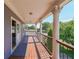 Relaxing covered balcony with wood floors, decorative railings, and classic columns at 3416 Harrison Rd, Atlanta, GA 30344