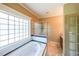 Bathroom showcasing a tub, glass shower, and natural light at 3416 Harrison Rd, Atlanta, GA 30344