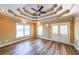 Bedroom showcasing decorative tray ceilings, wood-look floors, and French doors at 3416 Harrison Rd, Atlanta, GA 30344