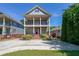 Charming two-story home boasts double balconies, landscaped front yard and a spacious driveway at 3416 Harrison Rd, Atlanta, GA 30344