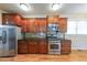 Modern kitchen featuring stainless steel appliances, dark cabinets, and granite counters for style at 3416 Harrison Rd, Atlanta, GA 30344