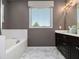 Bathroom featuring a soaking tub and a double sink vanity with marble floors at 1580 Johnson Nw Rd, Atlanta, GA 30318