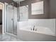 Bright bathroom showcasing a soaking tub, a glass-enclosed shower, and marble floors at 1580 Johnson Nw Rd, Atlanta, GA 30318
