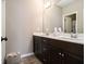 Bathroom featuring a double vanity with dark wood cabinetry, white countertops, and tiled floors at 1580 Johnson Nw Rd, Atlanta, GA 30318