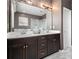 Bathroom with double vanity, stylish mirror, modern lighting, and walk-in shower at 1580 Johnson Nw Rd, Atlanta, GA 30318