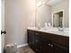 Bathroom featuring double sink vanity, white countertops, dark wood cabinets, and tiled floor at 1580 Johnson Nw Rd, Atlanta, GA 30318