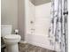 Full bathroom with a white shower-tub combination and gray floral shower curtain at 1580 Johnson Nw Rd, Atlanta, GA 30318