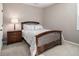 Cozy bedroom with a wood-framed bed, side table, lamp, and natural light at 1580 Johnson Nw Rd, Atlanta, GA 30318