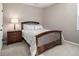 Cozy bedroom features a wood-framed bed, soft carpeting, and natural light at 1580 Johnson Nw Rd, Atlanta, GA 30318