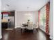 Bright dining area with dark wood floors, stylish chandelier, and natural light from a window with red floral curtains at 1580 Johnson Nw Rd, Atlanta, GA 30318