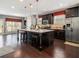 Modern kitchen with island, granite countertops, stainless steel appliances, and dark wood cabinetry at 1580 Johnson Nw Rd, Atlanta, GA 30318