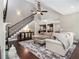 Open-concept living room showcasing staircase, fireplace, hardwood floors, and seamless flow to the kitchen at 1580 Johnson Nw Rd, Atlanta, GA 30318