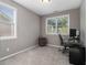 Well-lit office space featuring gray walls, plush carpeting, and natural light from two windows at 1580 Johnson Nw Rd, Atlanta, GA 30318