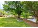Park view featuring lush greenery, a large shade tree, park benches and a pond at 1580 Johnson Nw Rd, Atlanta, GA 30318
