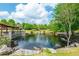 Scenic pond view with a fountain, pergola seating area, and lush green landscaping creating a serene community space at 1580 Johnson Nw Rd, Atlanta, GA 30318