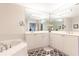 Bathroom featuring double sinks, a garden tub, and ample storage at 211 Colonial Homes Nw Dr # 2203, Atlanta, GA 30309