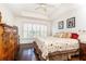 Relaxing bedroom with tray ceiling, shutters, and hardwood floors at 211 Colonial Homes Nw Dr # 2203, Atlanta, GA 30309