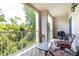 Spacious outdoor patio with seating, small table, grill, and green view at 211 Colonial Homes Nw Dr # 2203, Atlanta, GA 30309