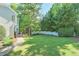 Expansive backyard with lush greenery, a privacy fence, and a charming garden at 2250 Edgemere Lake Cir, Marietta, GA 30062