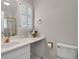 Bathroom featuring a white vanity with gold fixtures and a window with shutters at 2250 Edgemere Lake Cir, Marietta, GA 30062